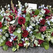 Burgundy and blue casket spray 